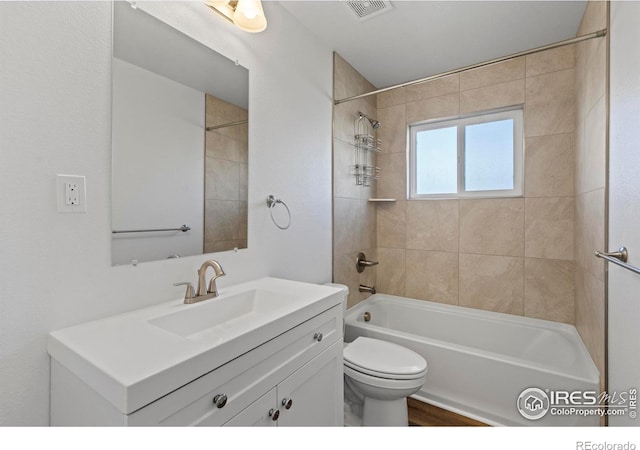 bathroom featuring visible vents, shower / bathing tub combination, vanity, and toilet