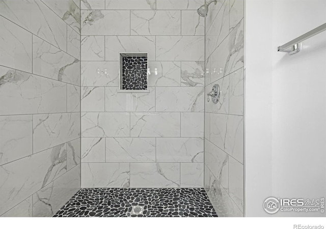 bathroom with tiled shower