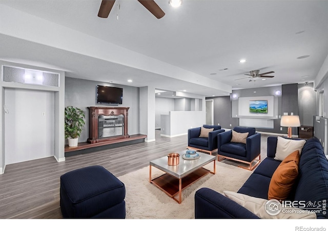 living room with a ceiling fan, recessed lighting, baseboards, and wood finished floors