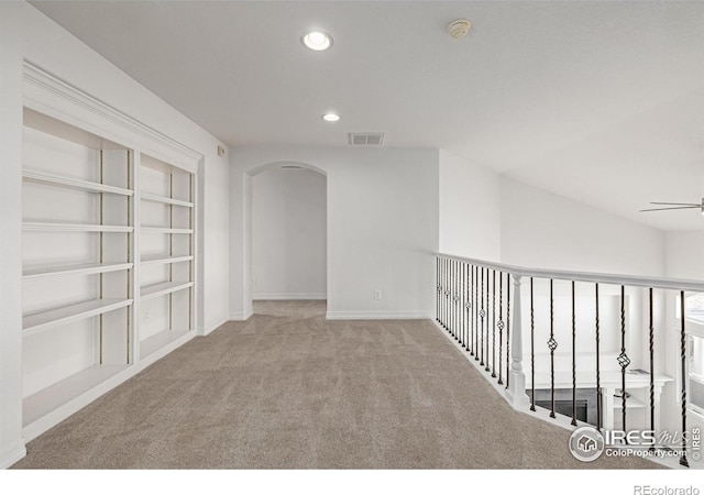 unfurnished room with visible vents, arched walkways, ceiling fan, carpet flooring, and recessed lighting