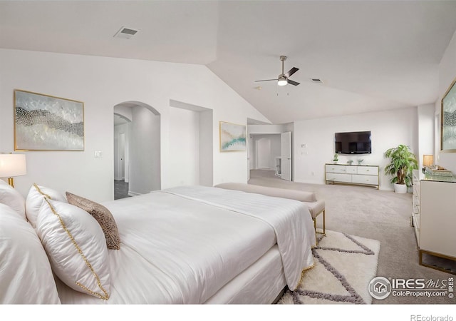 bedroom featuring arched walkways, vaulted ceiling, carpet, and visible vents