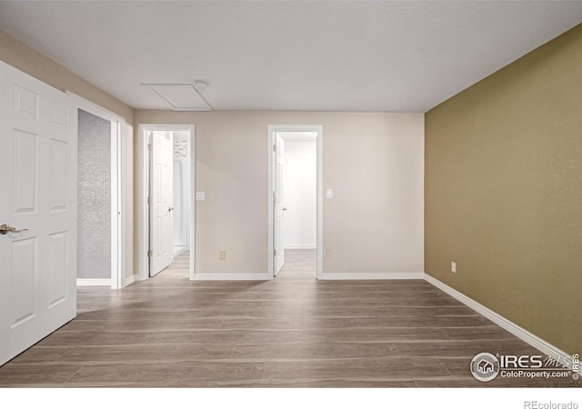 empty room featuring baseboards and wood finished floors