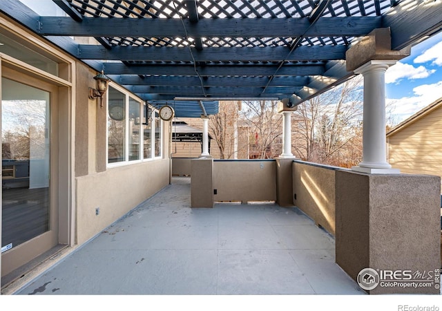 view of patio with a balcony and a pergola