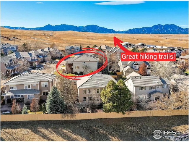 drone / aerial view featuring a residential view and a mountain view