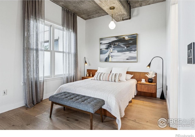 bedroom with light wood-style flooring and baseboards