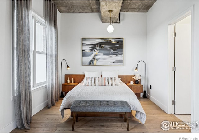 bedroom featuring light wood-type flooring and baseboards