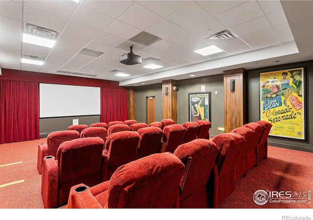 carpeted home theater room with a paneled ceiling and visible vents