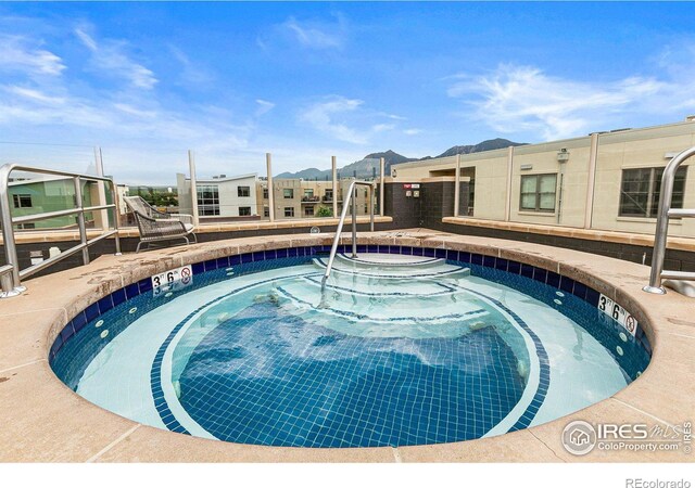 view of pool with a community hot tub