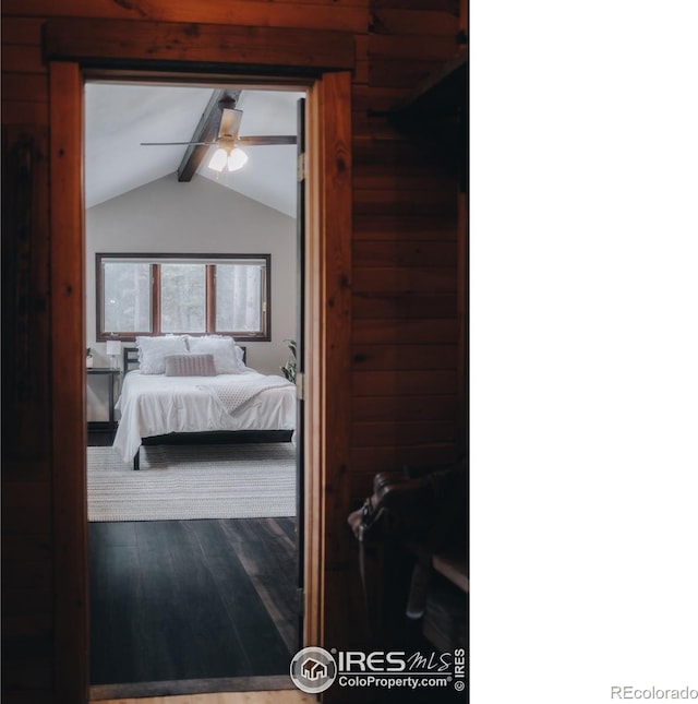 bedroom with lofted ceiling with beams, wood finished floors, and a ceiling fan