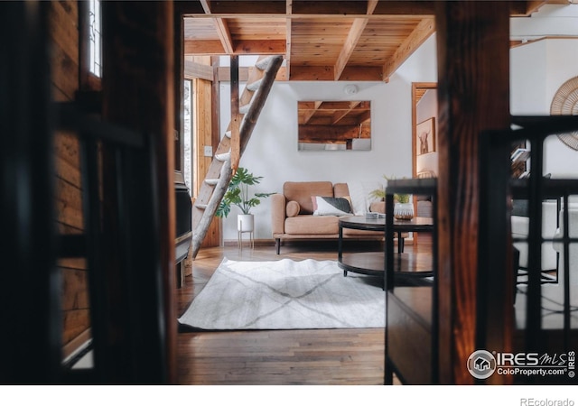 sitting room with wooden ceiling, wood finished floors, and beamed ceiling