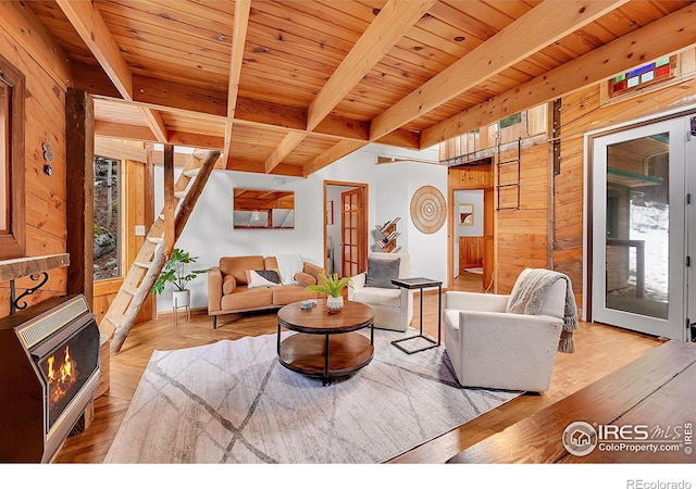 living area featuring wooden ceiling, beamed ceiling, and heating unit