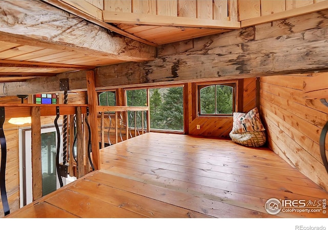 interior space with wood walls and hardwood / wood-style flooring