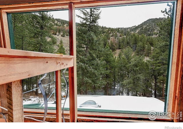 doorway to outside with a mountain view and a wooded view