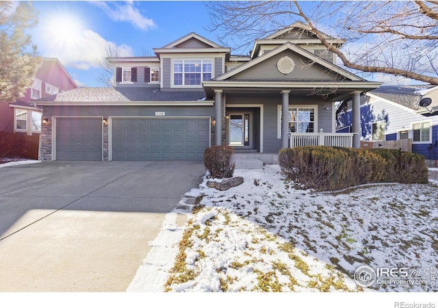 view of front of property featuring covered porch, concrete driveway, and a garage