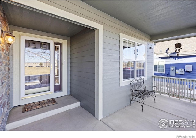 view of exterior entry with covered porch