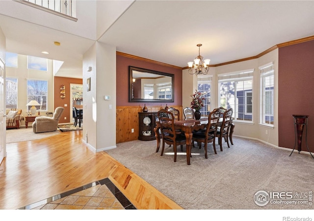 dining room with an inviting chandelier, baseboards, and crown molding