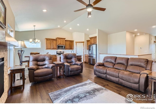 living area featuring high vaulted ceiling, recessed lighting, ceiling fan with notable chandelier, dark wood-style flooring, and a fireplace