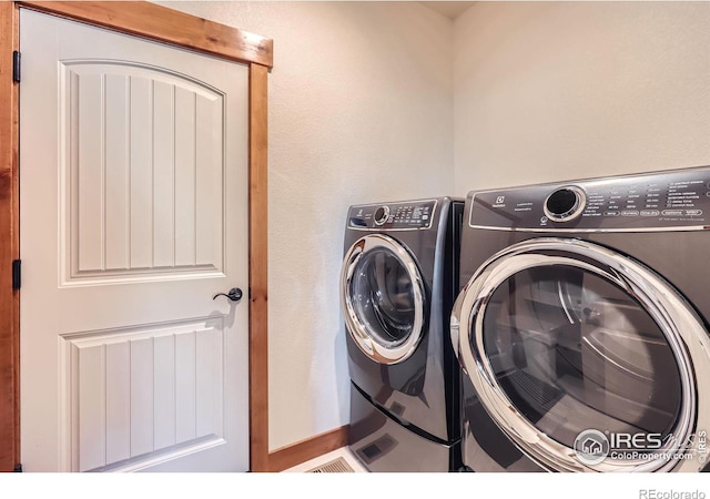 washroom featuring laundry area and washer and dryer