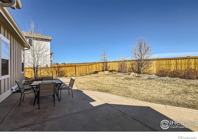 view of patio with outdoor dining space and a fenced backyard