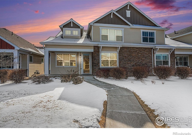 view of front of property featuring stone siding and board and batten siding