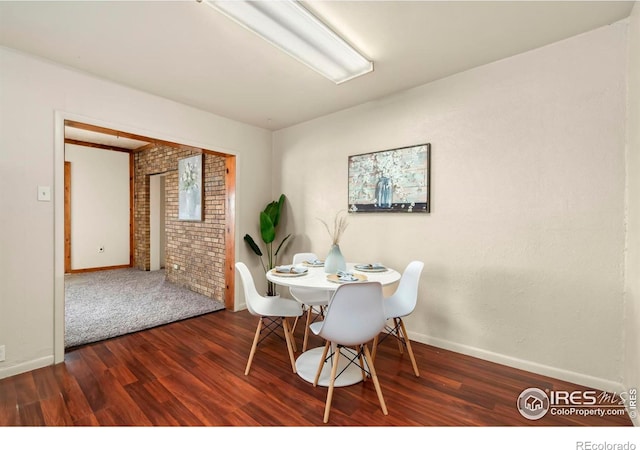 dining room featuring baseboards and dark wood finished floors