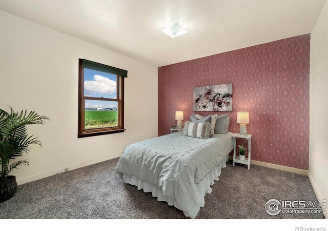 carpeted bedroom with wallpapered walls and baseboards