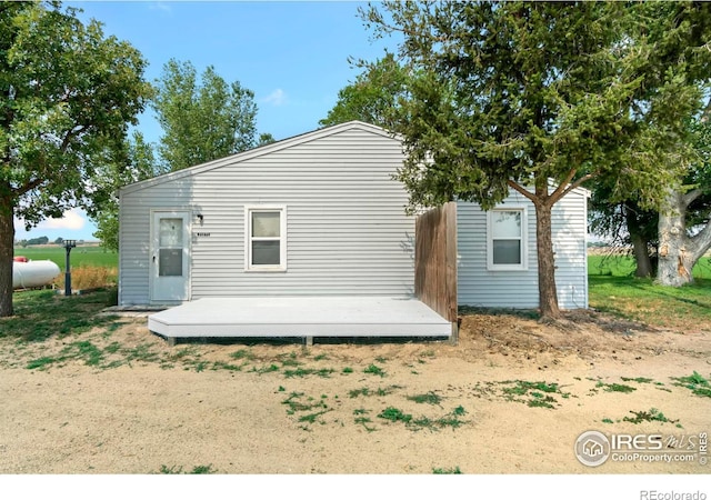 back of property with a wooden deck