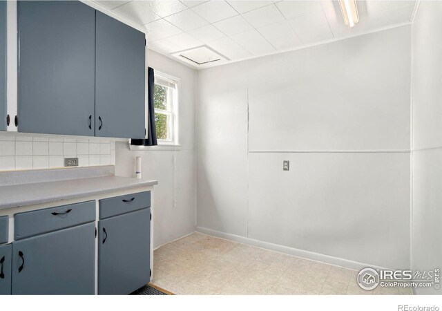 kitchen with decorative backsplash, light countertops, and light floors