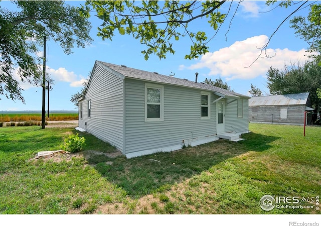 back of house featuring a lawn