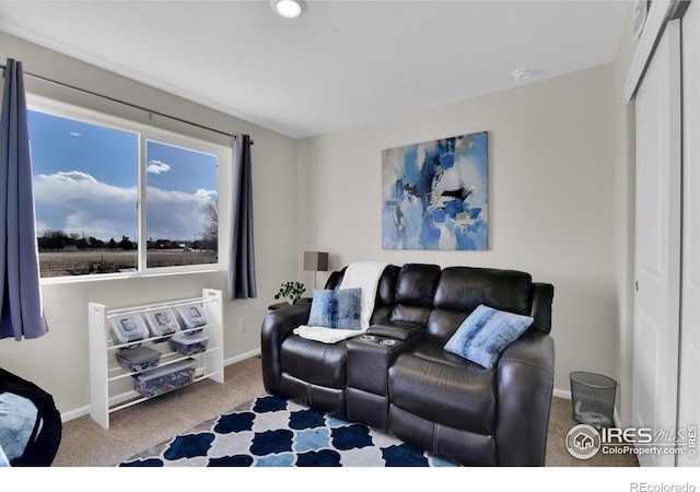 carpeted living area featuring baseboards