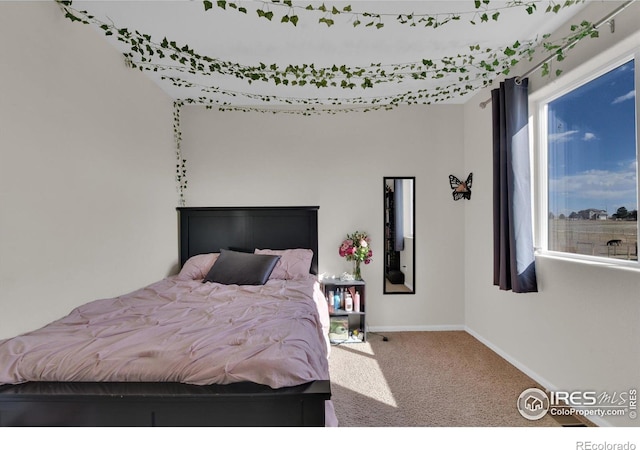 bedroom with carpet and baseboards