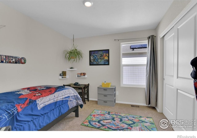 bedroom featuring carpet floors, a closet, visible vents, and baseboards