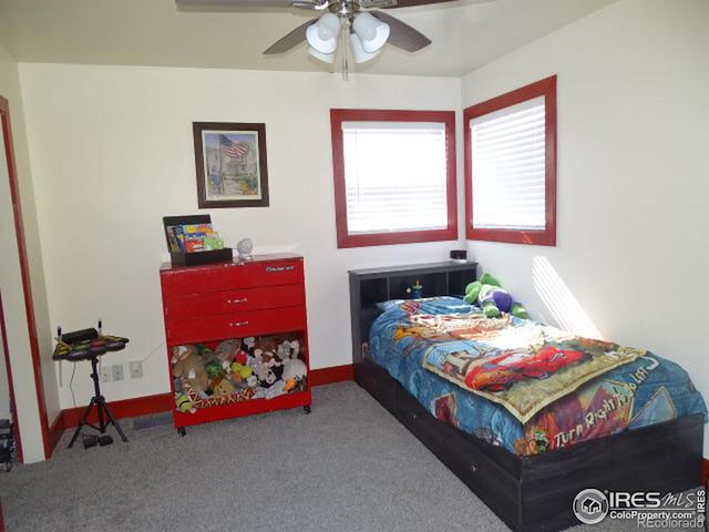 carpeted bedroom with baseboards and a ceiling fan