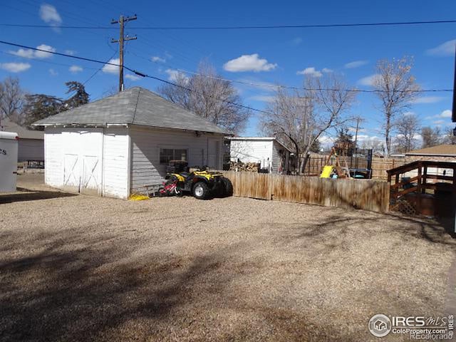 exterior space with fence and an outbuilding