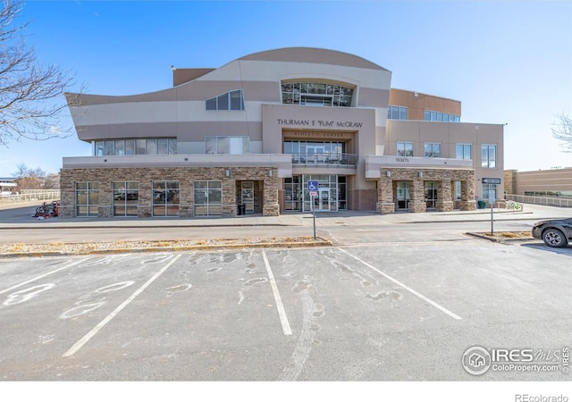 view of property featuring uncovered parking