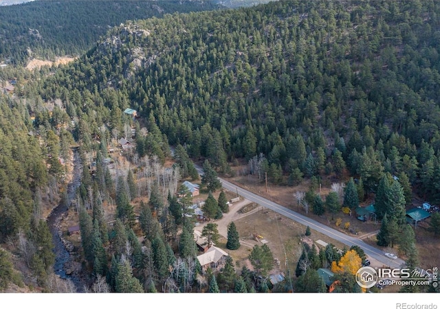 aerial view featuring a wooded view