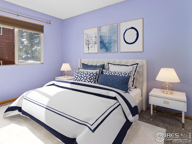 bedroom featuring carpet flooring and baseboards