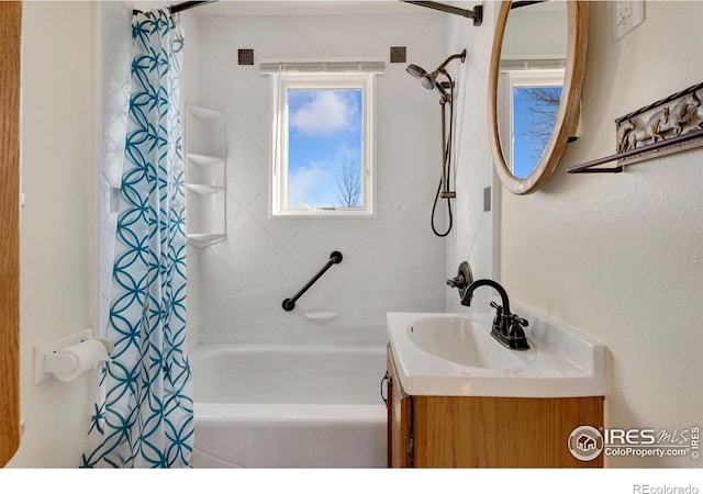 bathroom with shower / bath combo with shower curtain and vanity