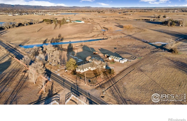 aerial view with a mountain view, a desert view, and a rural view