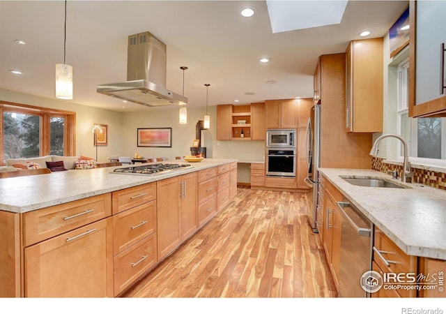 kitchen with pendant lighting, a large island, and island range hood