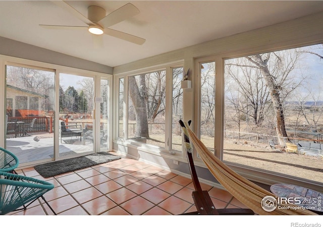 unfurnished sunroom with plenty of natural light and ceiling fan