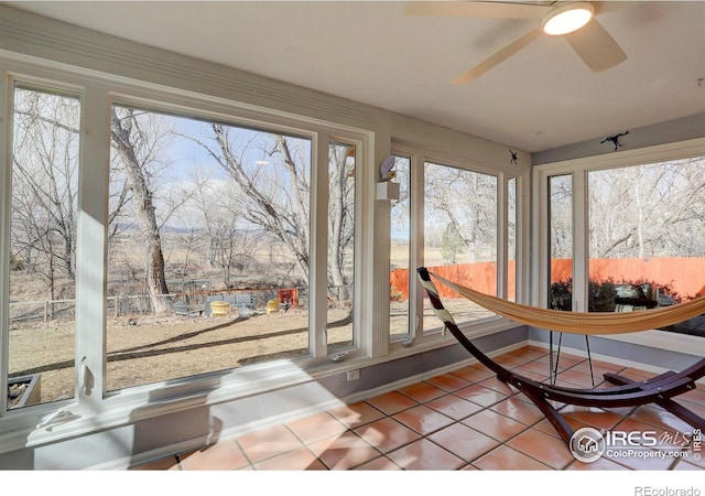 sunroom / solarium featuring a wealth of natural light and a ceiling fan