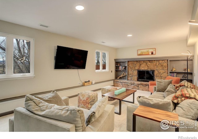 living room with light carpet, a fireplace, visible vents, and recessed lighting