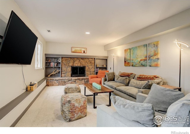 living room featuring a fireplace, visible vents, and recessed lighting