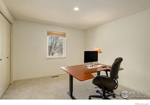 office area featuring recessed lighting, light colored carpet, visible vents, and a textured ceiling