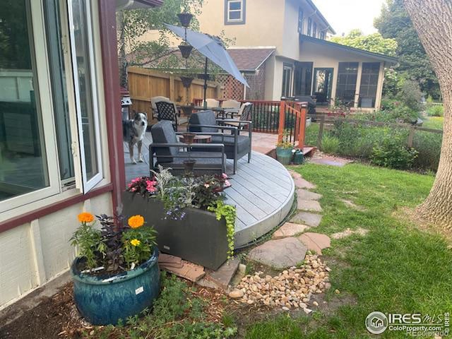 view of yard featuring fence and a deck