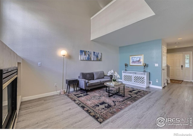 living room featuring baseboards and wood finished floors