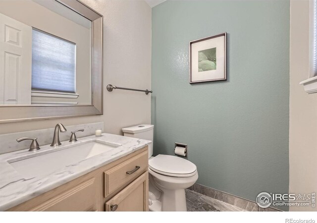 half bath with vanity and toilet