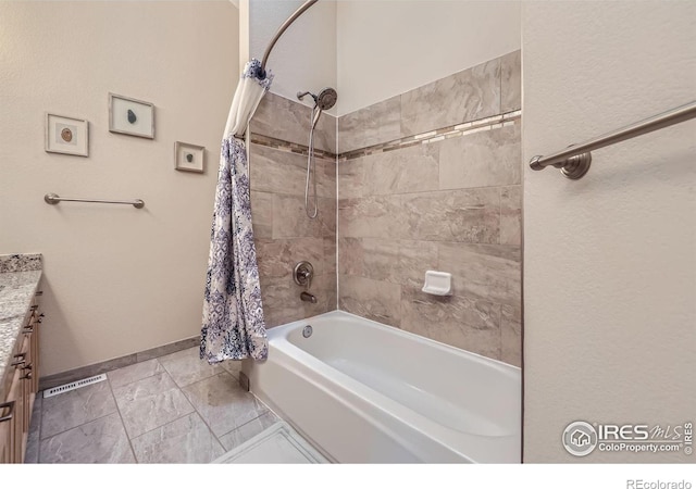 bathroom featuring baseboards, vanity, and shower / tub combo with curtain