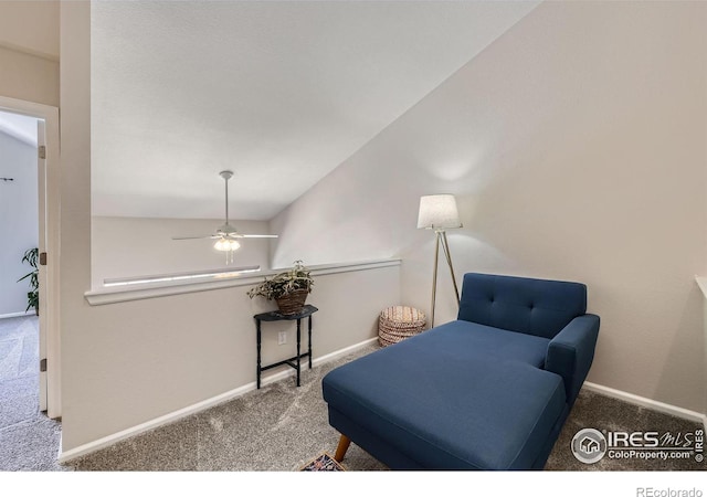 living area with carpet floors, lofted ceiling, baseboards, and a ceiling fan